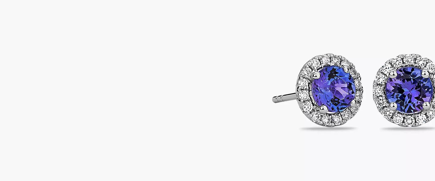 Round tanzanite gemstones featured in diamond halo stud earrings